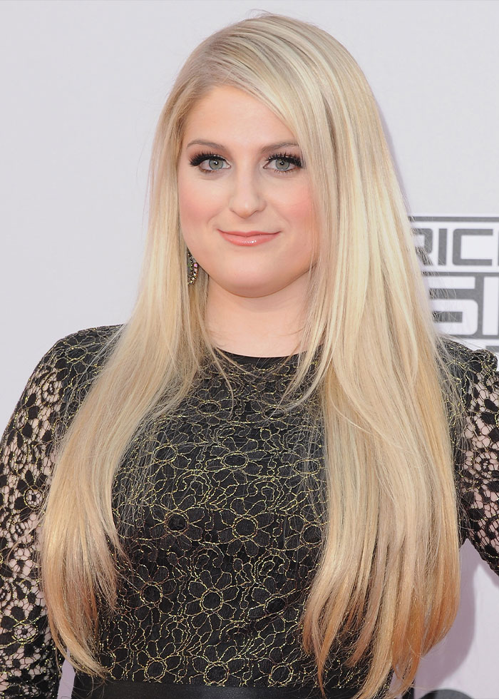 Meghan Trainor with long blonde hair and black lace dress, highlighting her new look that fans find hilarious. Meghan Trainor with long blonde hair and black lace dress, highlighting her new look that fans find hilarious.