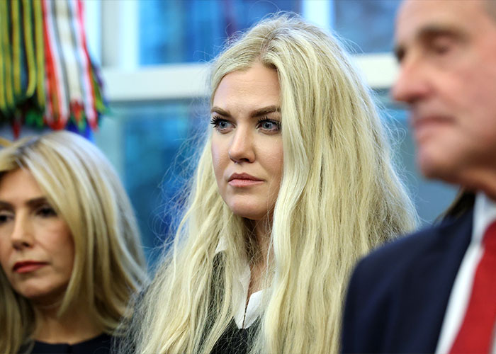 Erika Kirk with long blonde hair showing emotional gestures while crying in a tense and dramatic moment Erika Kirk with long blonde hair showing emotional gestures while crying in a tense and dramatic moment