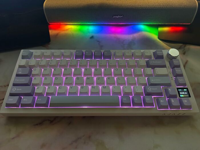 RGB backlit mechanical keyboard with digital display, perfect for Black Friday week tech deals and gaming setups.