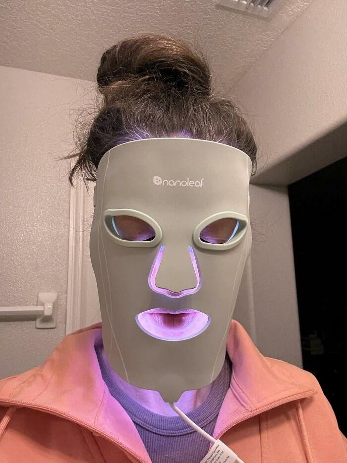 Person wearing a Nanoleaf LED mask with glowing purple lights featured in Cyber Monday deals this year.