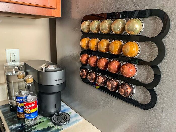 Coffee pod holder mounted on wall next to coffee maker, showcasing a viral product trending on TikTok algorithm.