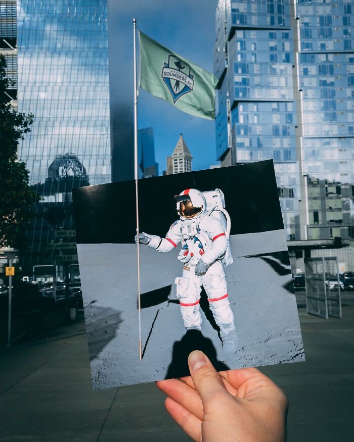 Hand holding a paper cutout of an astronaut interacting with a real flagpole in an urban cityscape. Hand holding a paper cutout of an astronaut interacting with a real flagpole in an urban cityscape.