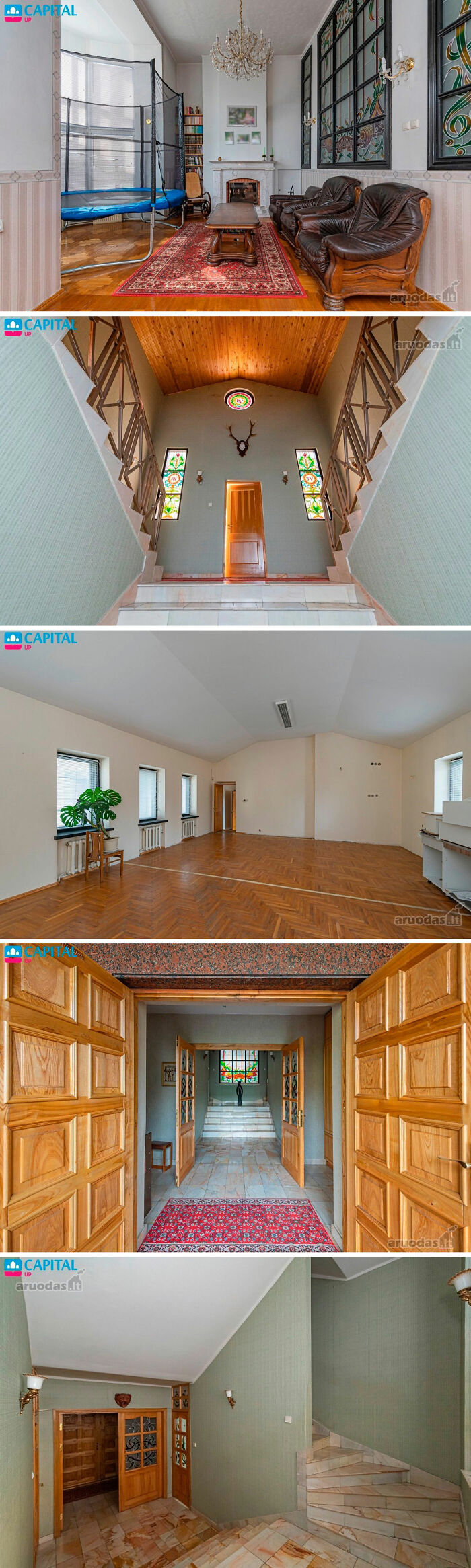 Living room with trampoline, vintage furniture, and staircase with stained glass windows in wild real estate listings.