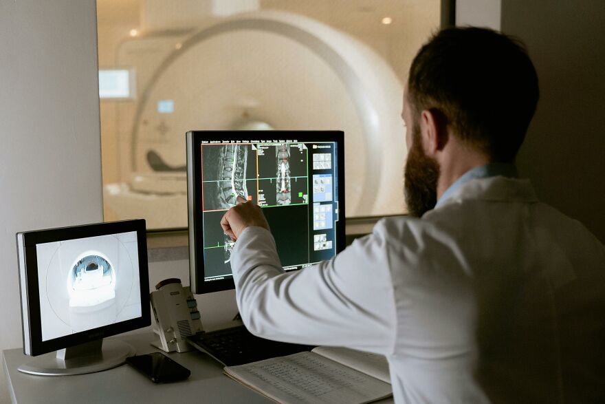 Doctor examining MRI scans of a broken bone, related to the broken bone theory in a medical setting. Doctor examining MRI scans of a broken bone, related to the broken bone theory in a medical setting.