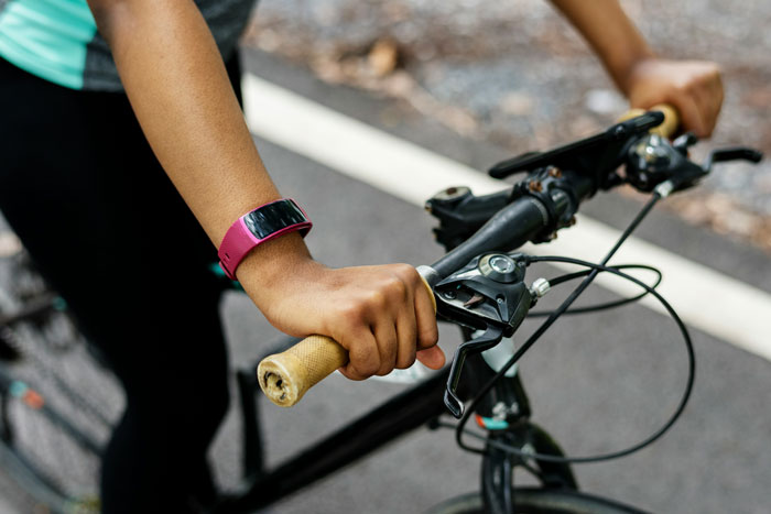 Close-up of a person’s hands on bike handlebars, capturing a candid moment related to instant karma on the road.