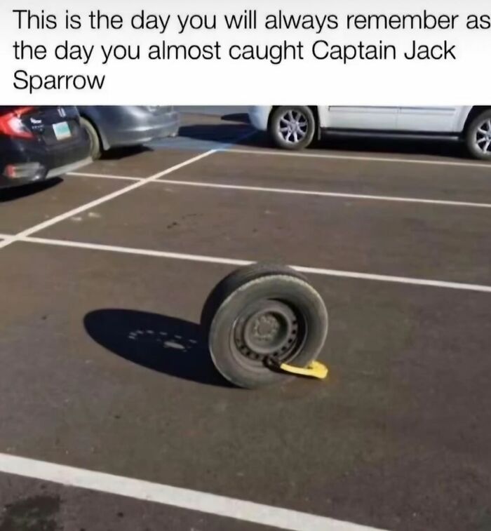 A funny meme showing a car wheel with a parking boot in an empty parking lot, part of randomly funny memes.