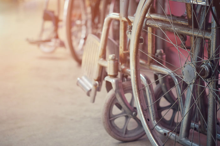 Close-up of old wheelchair wheels showing rust and wear, evoking creepy and terrifying urban explorer moments.
