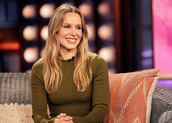 Kristen Bell smiling and seated during a talk show interview discussing Fox Faith Project and related controversy.