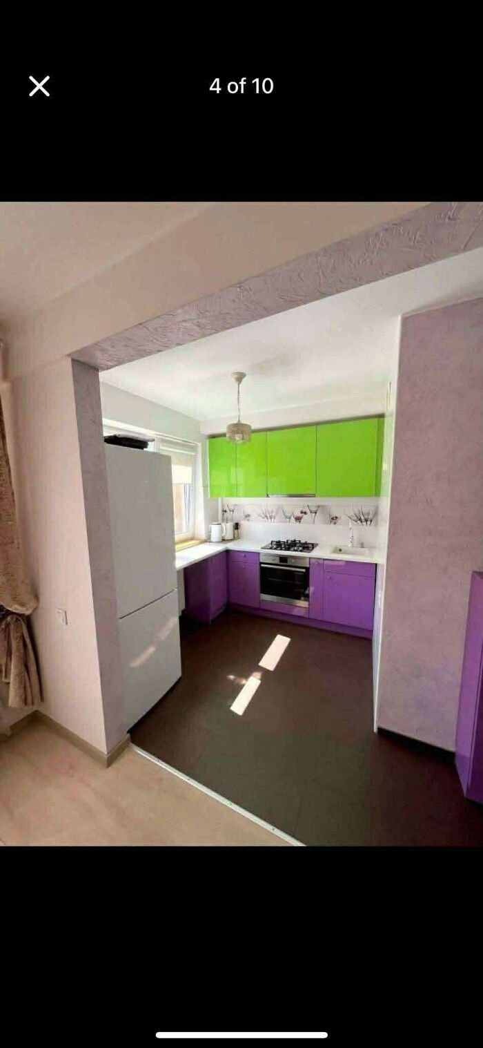 Small kitchen with bright green and purple cabinets, white appliances, and modern decor in wild real estate listings.