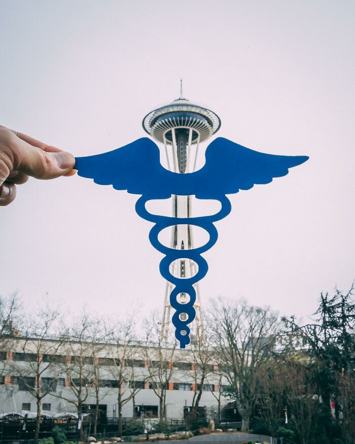 Blue paper cutout interacting with real-life Seattle Space Needle in creative art by Rudy Willingham. Blue paper cutout interacting with real-life Seattle Space Needle in creative art by Rudy Willingham.