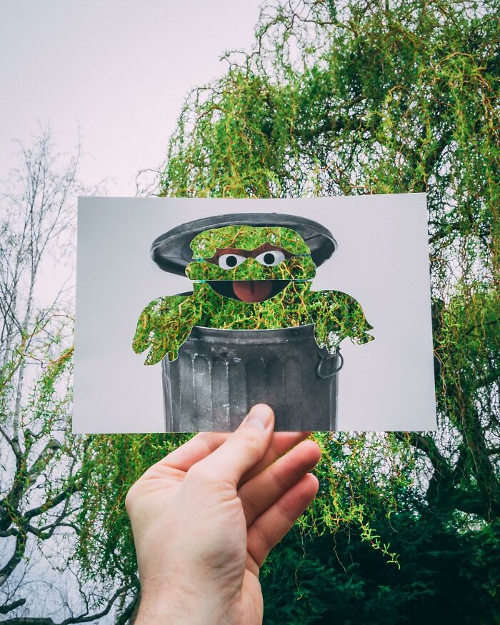 Hand holding paper cutouts of a trash can and character with real-life tree leaves perfectly integrated in background. Hand holding paper cutouts of a trash can and character with real-life tree leaves perfectly integrated in background.