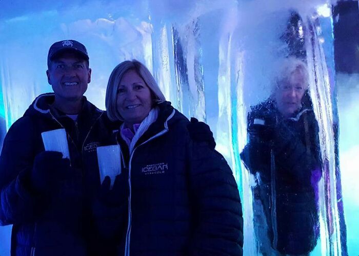 Couple posing inside icebar with a photobomb behind them made everyone laugh in an epic photobomb moment.