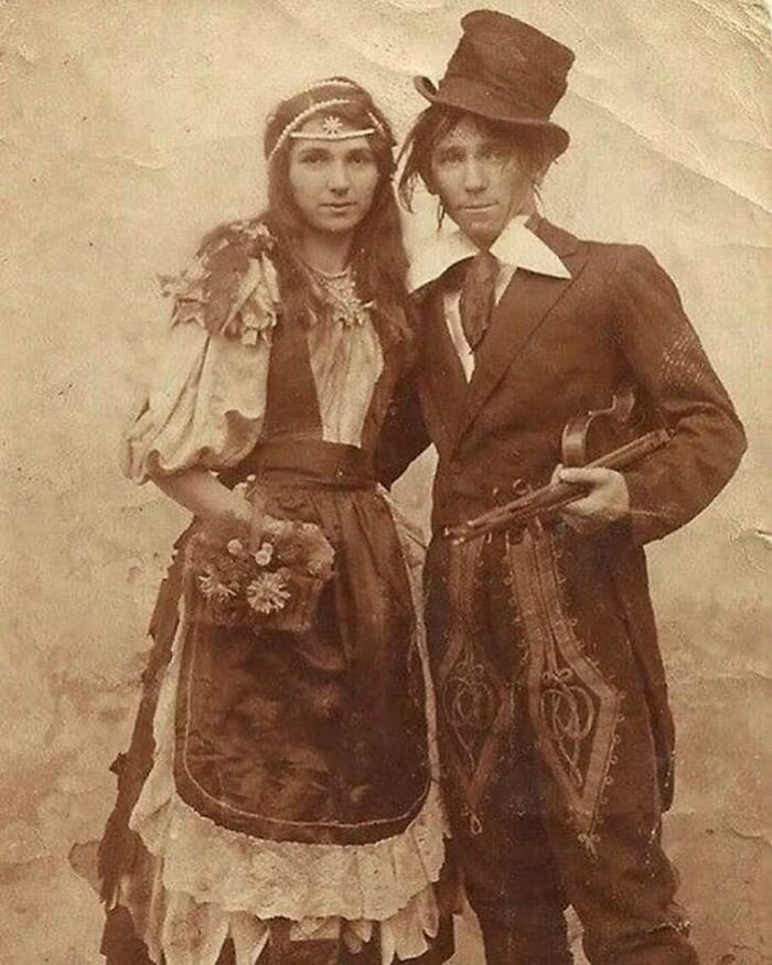 Couple in Victorian era costumes posing for a weird photo, reflecting unique fashion from the Victorian era.