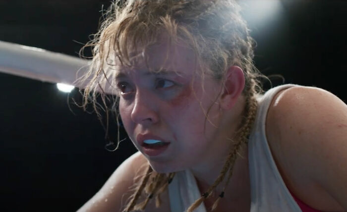Sydney Sweeney looking exhausted with braided hair and sweat after intense boxing scene, related to Christy box office damage control. Sydney Sweeney looking exhausted with braided hair and sweat after intense boxing scene, related to Christy box office damage control.