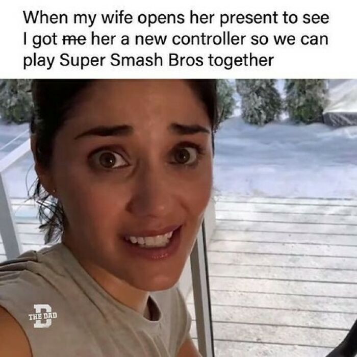 Wife reacting to a new controller gift with a surprised face, perfect for funny memes for dads who just want to game in peace.