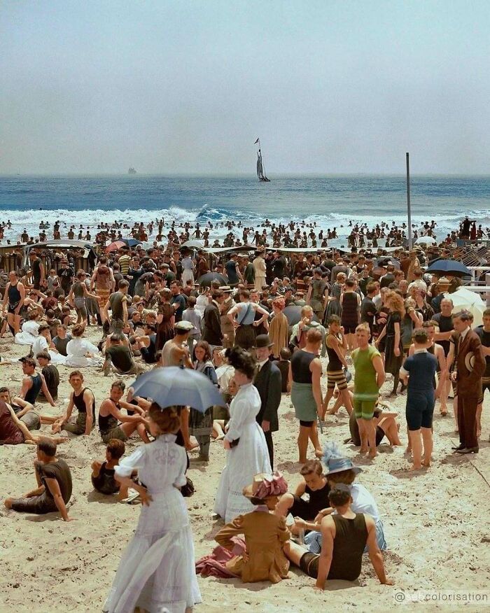 Crowded Victorian-era beach scene with people in period swimwear and clothing, showcasing weird photos from the Victorian era.