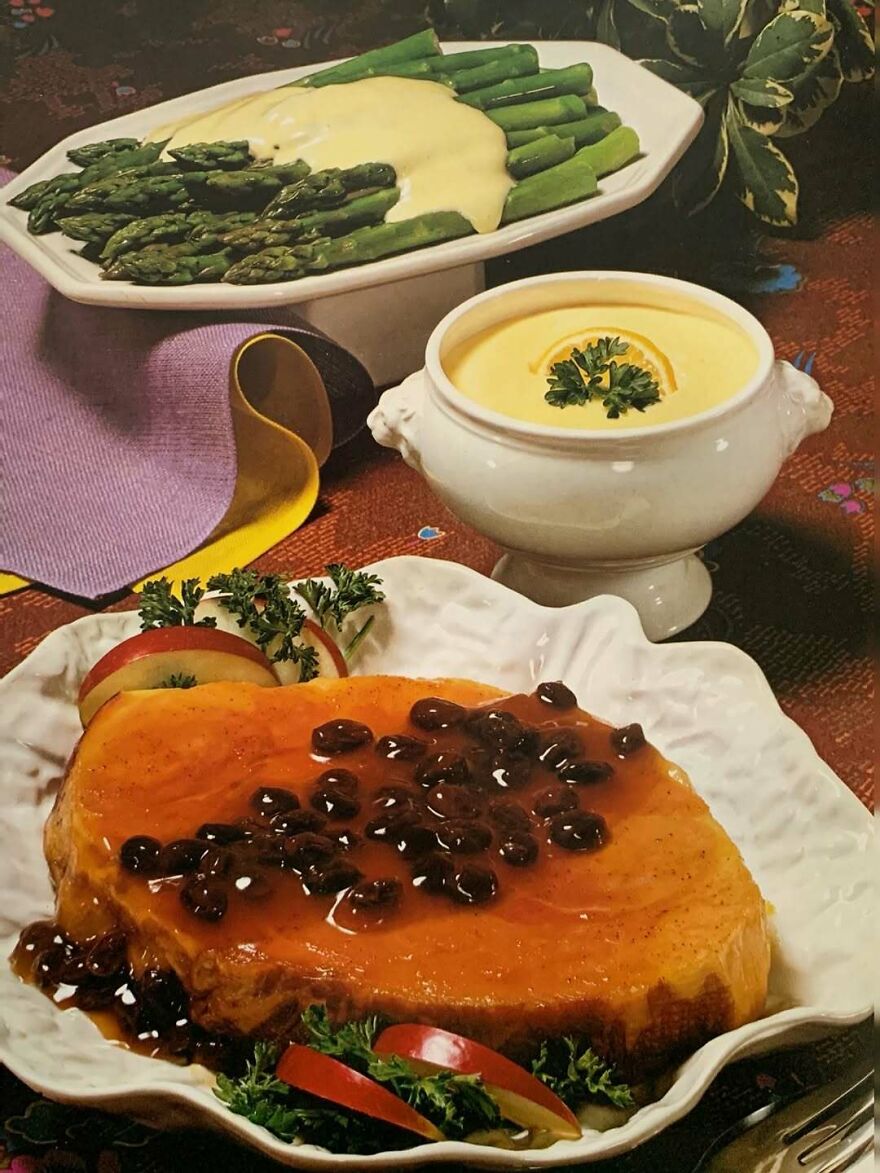 Vintage recipes featuring glazed ham with raisins, creamed asparagus, and a vintage lemon sauce on a decorative table setting.