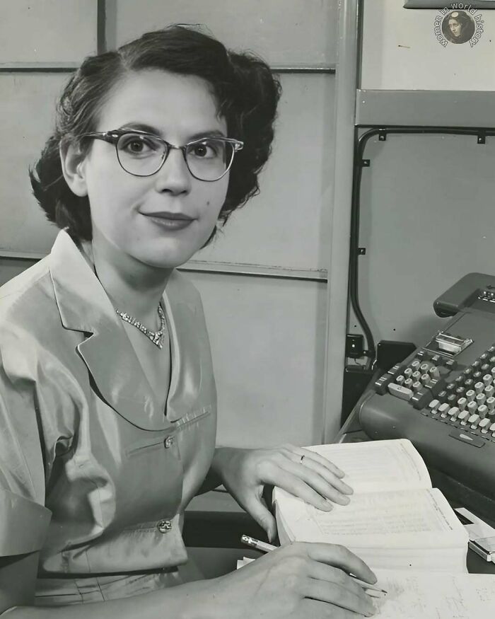 Young woman overlooked in history working with vintage calculator, highlighting important achievements of women in history.