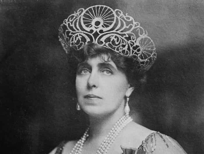 Portrait of a historic woman wearing an ornate headpiece and pearls, representing overlooked women in history achievements.