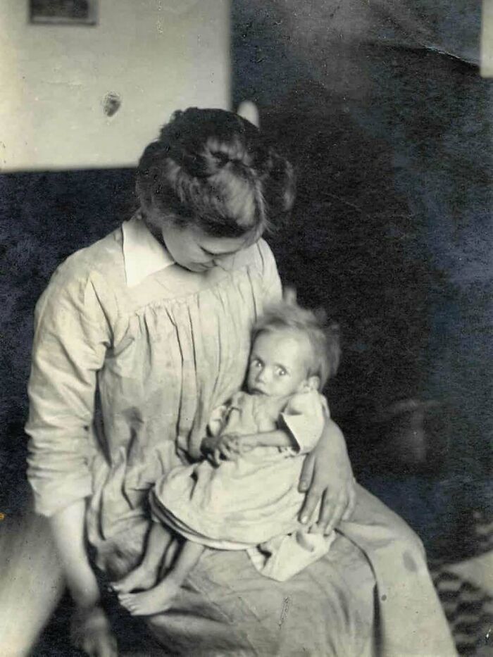 Victorian era photo of a woman holding a frail child, reflecting the unusual and different times of the period.