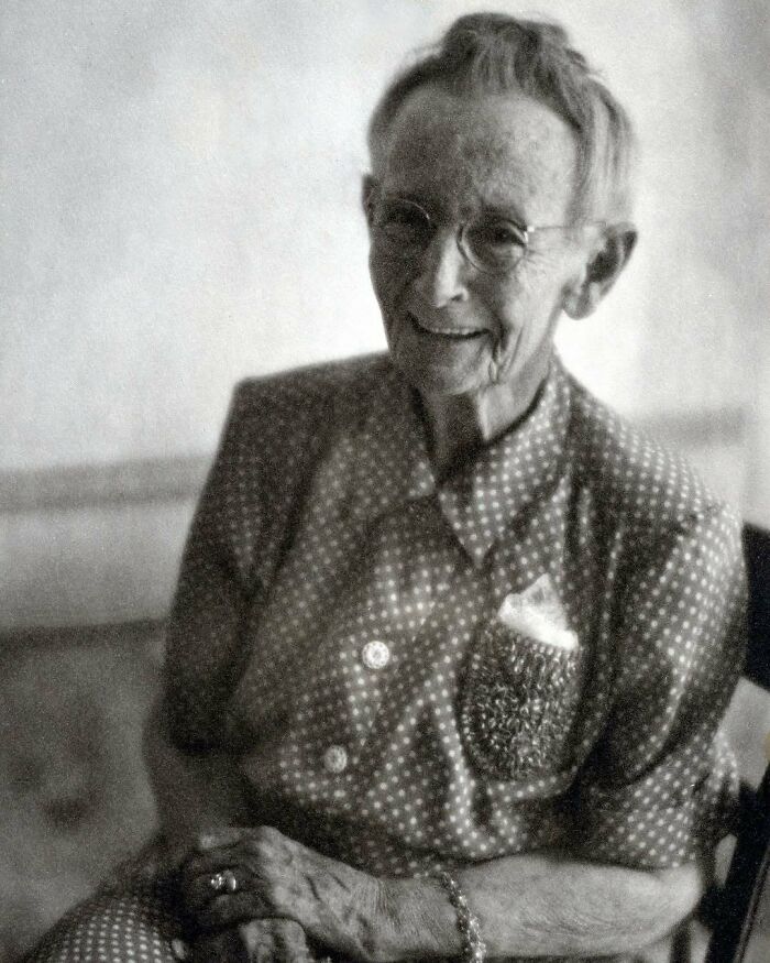 Elderly woman smiling gently, representing overlooked women in history and their important achievements.