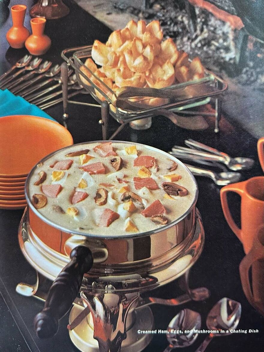 Vintage recipes featuring creamed ham, eggs, and mushrooms in a classic mid-century serving dish with retro tableware.