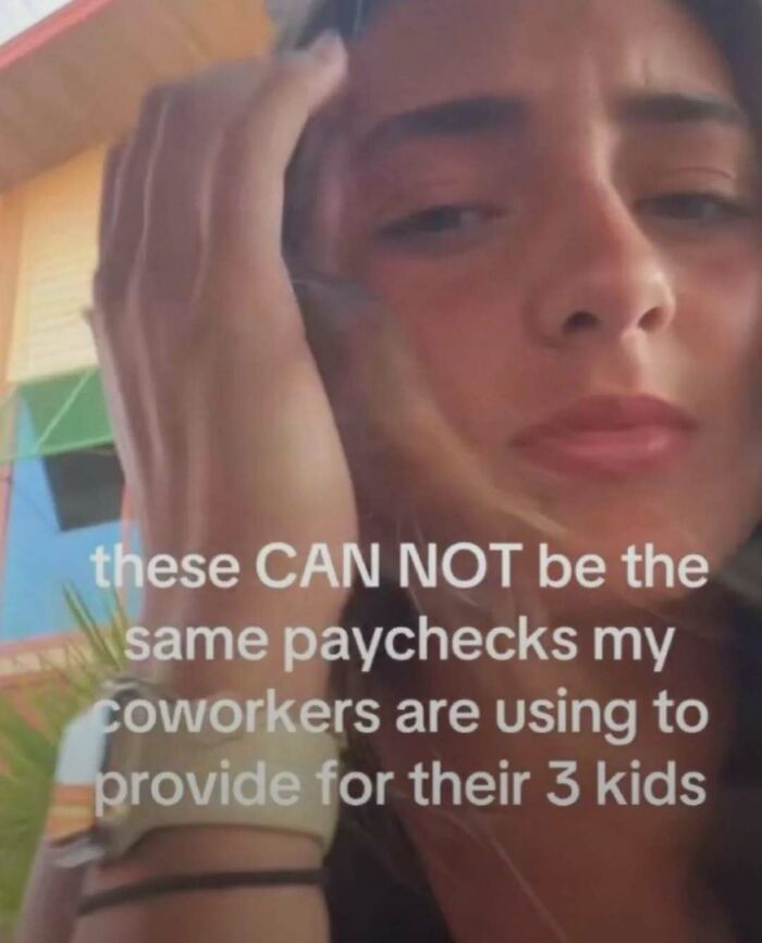 Person with hand on head, showing disbelief, with text about paychecks and coworkers, related to laughgorithm memes.