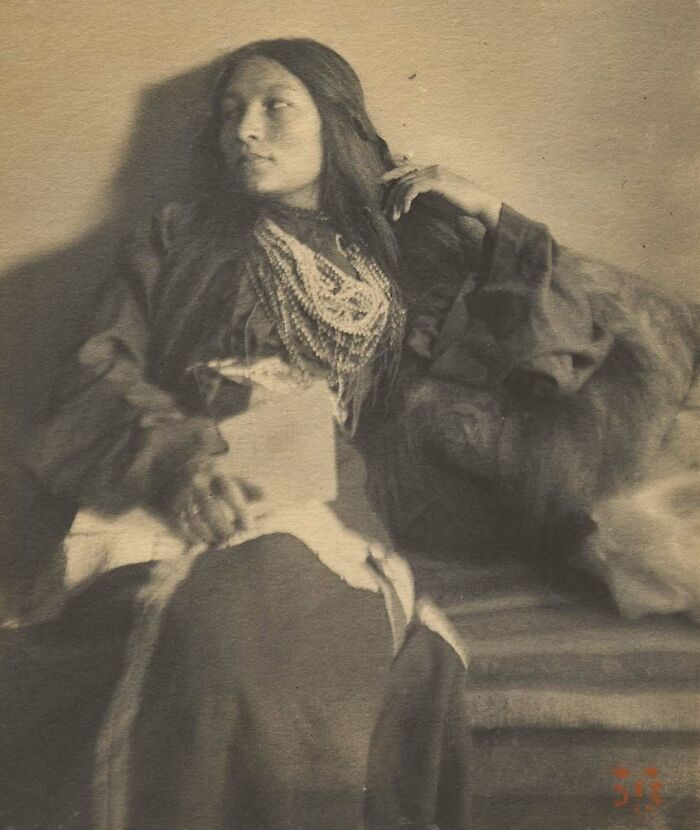 Historic sepia photo of a woman wearing traditional necklace, representing overlooked women in history and their achievements.