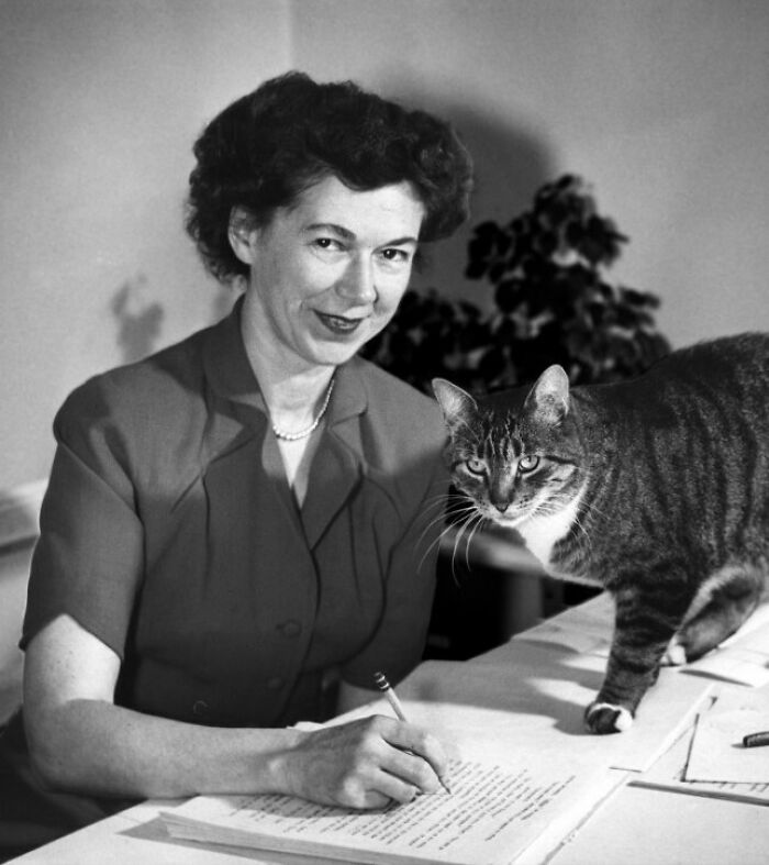 Black and white photo of a woman with a cat, representing overlooked women in history and their achievements.