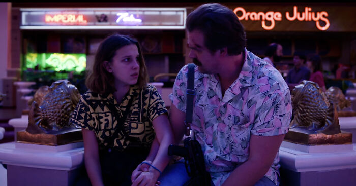 Millie Bobby Brown and David Harbour in a tense scene highlighting their complex relationship amid harassment allegations.