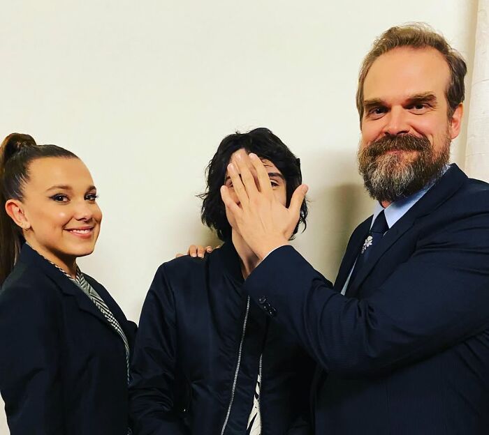 Millie Bobby Brown and David Harbour posing together, highlighting their complex 10-year relationship amid allegations.