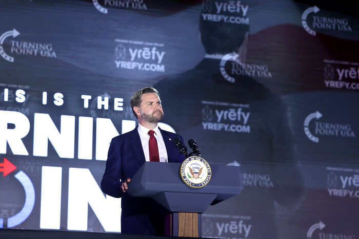 JD Vance speaking at a Turning Point USA event, with lip reader revealing his emotional exchange with Erika Kirk. JD Vance speaking at a Turning Point USA event, with lip reader revealing his emotional exchange with Erika Kirk.