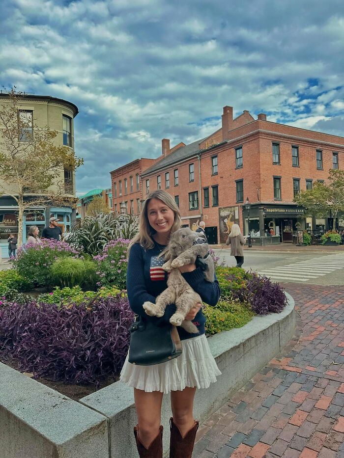 Woman holding a large rabbit outdoors, illustrating Hoppy Gilmore’s journey from frail rabbit to affectionate companion. Woman holding a large rabbit outdoors, illustrating Hoppy Gilmore’s journey from frail rabbit to affectionate companion.