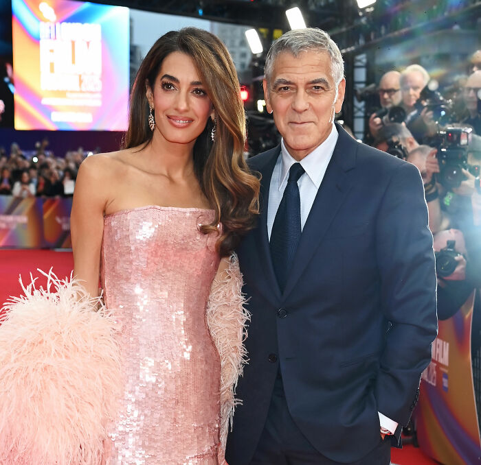 Amal Clooney and George Clooney on red carpet amid major Photoshop blunder and Vogue editing controversy. Amal Clooney and George Clooney on red carpet amid major Photoshop blunder and Vogue editing controversy.