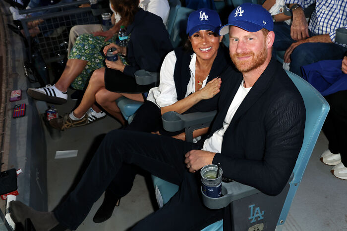 Meghan Markle and Prince Harry attending a Dodgers game, sparking debate over their staged celebration at home. Meghan Markle and Prince Harry attending a Dodgers game, sparking debate over their staged celebration at home.