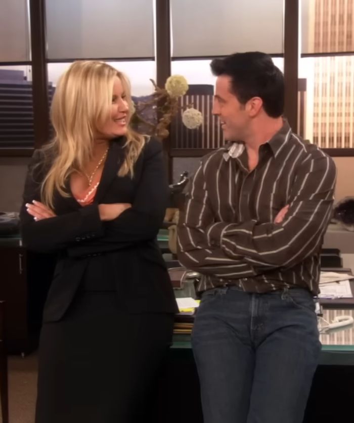 Matt LeBlanc as Joey in unaired episodes, smiling and talking with a blonde woman in an office setting.