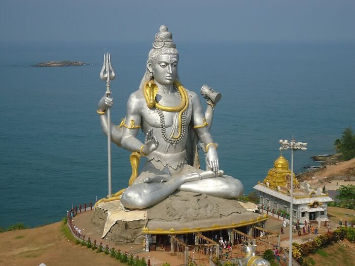 Massive silver Lord Shiva sculpture by the sea, one of the spectacular sculptures across the globe for travel bucket lists.