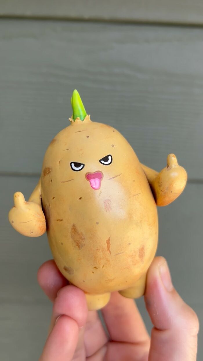 Hand holding quirky sculpture of a potato character with expressive eyes and tongue out, bursting with personality.