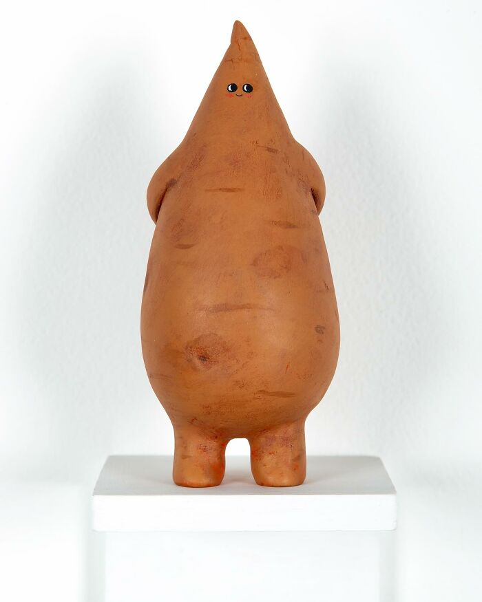 Quirky sculpture with a pointed head and smiling face, showcasing personality and playful artistic design.