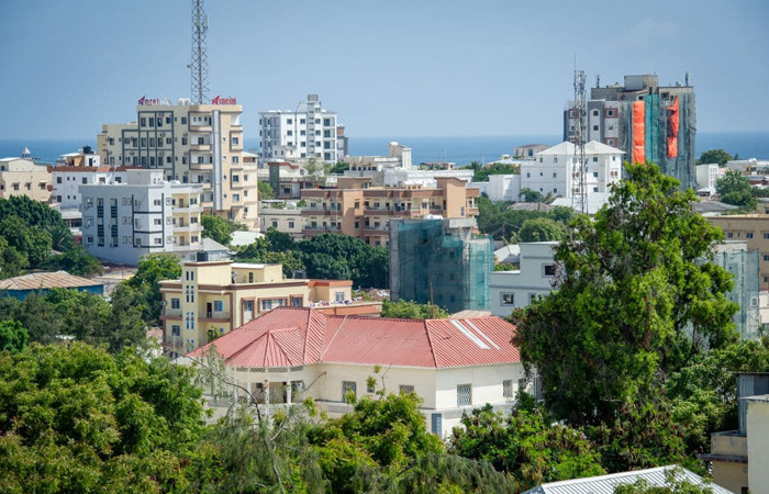 Cityscape showing buildings and greenery in the poorest country in the world facing dire hardship conditions.