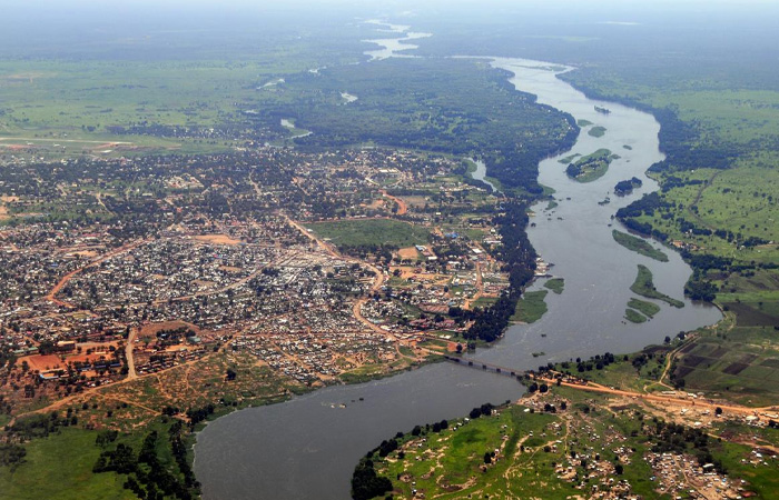Aerial view of the poorest country in the world with a river winding through a struggling urban and rural landscape.