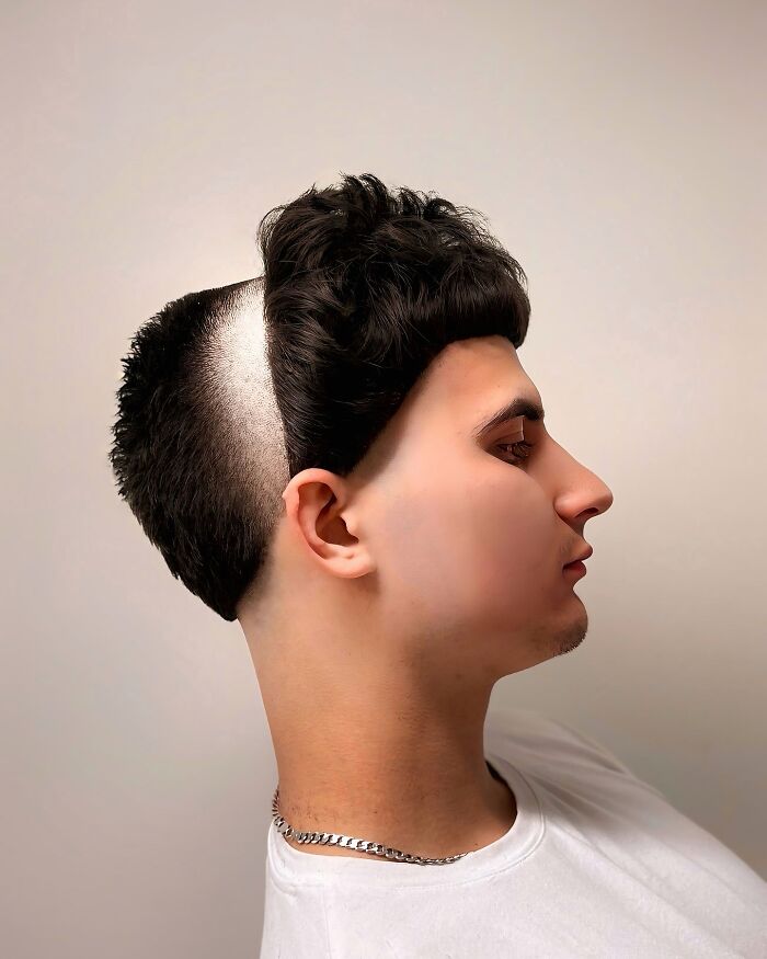 Young man with bold barber haircut featuring a high contrast shaved side and textured top, showcasing next level style creativity.