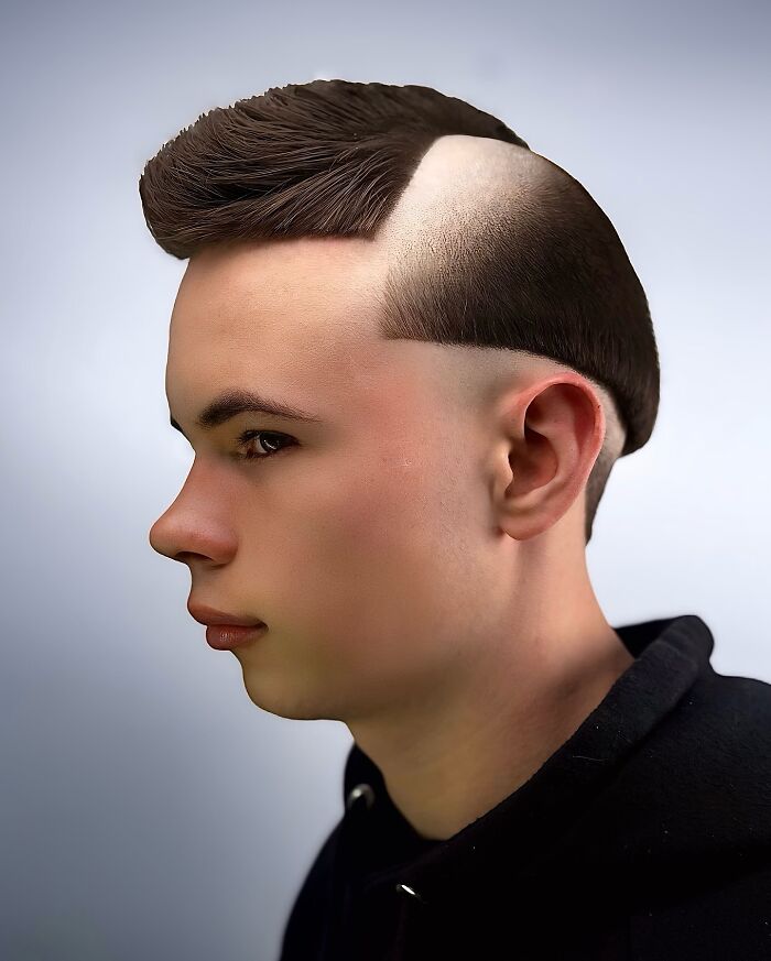 Young man with a bold barber haircut featuring a sharp undercut and styled top hair in a modern edgy design.