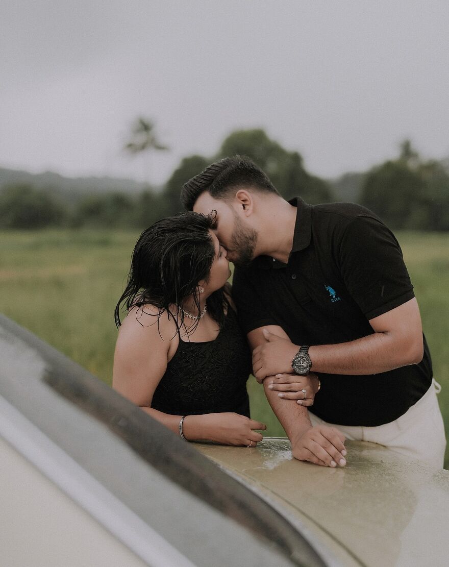 Couple sharing a gentle kiss outdoors, illustrating different types of kisses and their cultural significance.