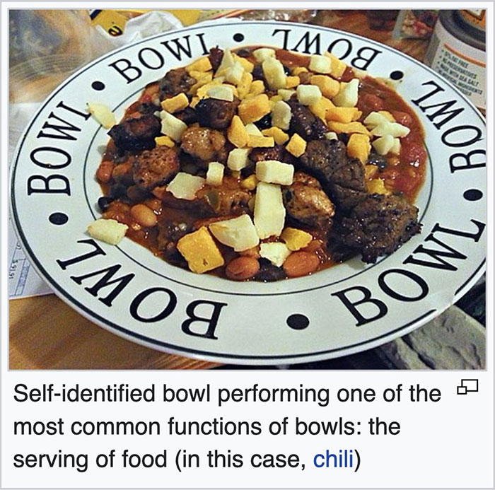 Plate labeled bowl filled with chili topped with cheese, showcasing a funny Wikipedia gem about bowls and food serving.