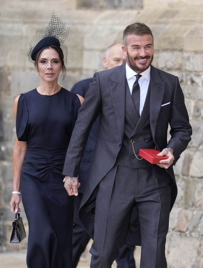 Victoria Beckham and David Beckham dressed formally, celebrating after David receives a Sir title at a public event. Victoria Beckham and David Beckham dressed formally, celebrating after David receives a Sir title at a public event.