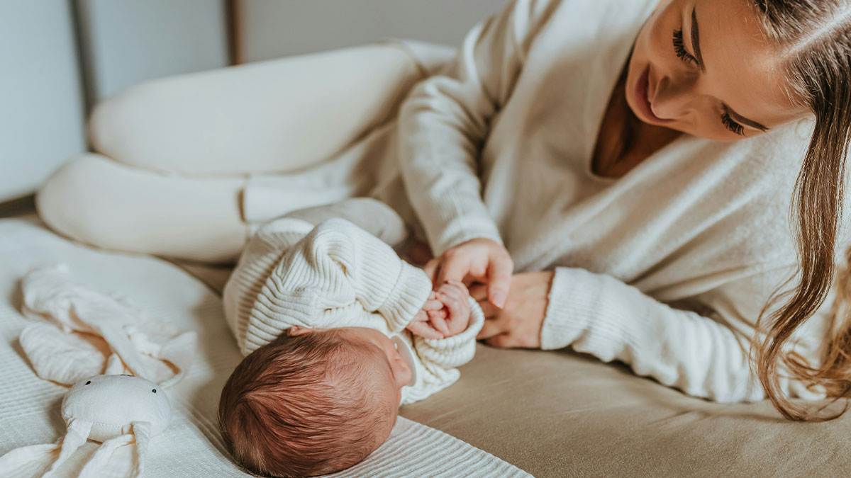 Mother and newborn bonding in cozy home setting, highlighting the experience of American expats in Canada.