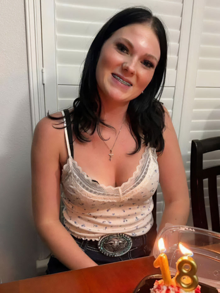 Young woman smiling at a table with birthday cake candles, relating to father of teen slain on cruise affair keywords. Young woman smiling at a table with birthday cake candles, relating to father of teen slain on cruise affair keywords.