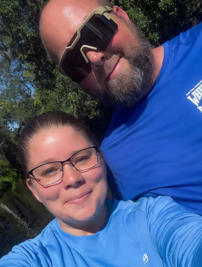 Man and woman outdoors, both wearing blue shirts, with stepbrother of teen slain in cruise mentioned in the context. Man and woman outdoors, both wearing blue shirts, with stepbrother of teen slain in cruise mentioned in the context.