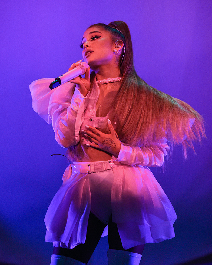 Ariana Grande performing on stage with a microphone, highlighting her cryptic last hurrah announcement. Ariana Grande performing on stage with a microphone, highlighting her cryptic last hurrah announcement.